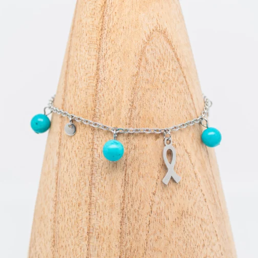 Bracelet artisanal Gine de sensibilisation à la lutte contre le cancer en Turquoise