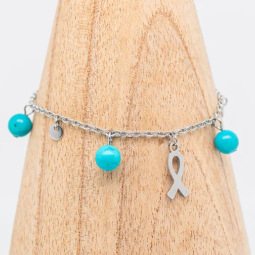 Bracelet artisanal Gine de sensibilisation à la lutte contre le cancer en Turquoise